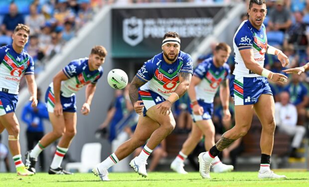 A rugby league player passes the ball to a teammate during an intense game, HD Desktop Wallpaper