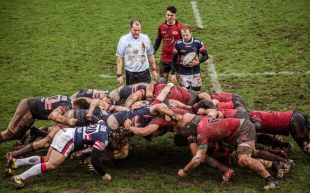 A rugby league scrum occurs during a match with players pushing against each other, HD Desktop Wallpaper