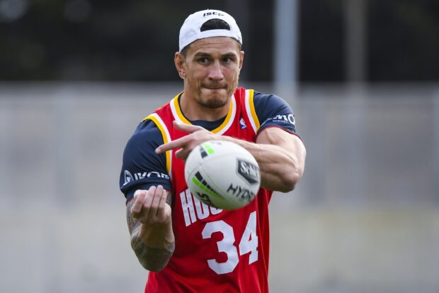 A rugby league player wearing a red jersey is catching the ball during practice, 2K Desktop Wallpaper