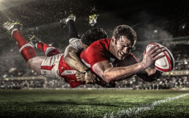 A rugby league player is diving to score while tackled by an opponent during a match, HD Desktop Wallpaper