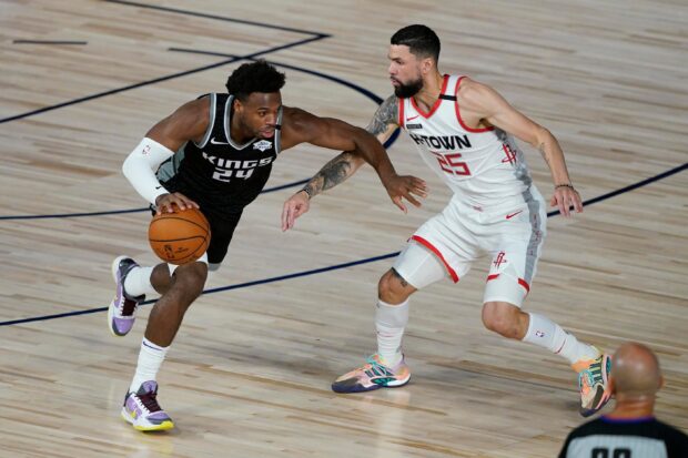 A Sacramento Kings player dribbles the basketball while being guarded during the game