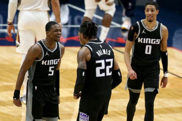 Sacramento Kings players celebrate a basketball play during the game on court