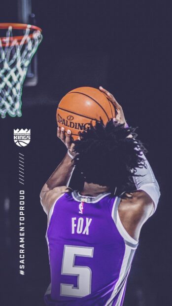 Sacramento Kings player Fox is preparing to shoot a basketball during a game