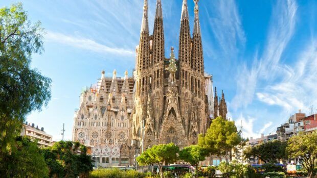 The Sagrada Familia stands tall under a vibrant blue sky in this Spain Wallpapers image, 2K Desktop Wallpaper