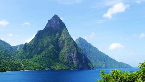The stunning Saint Lucia mountain covered in lush greenery beside the deep blue sea