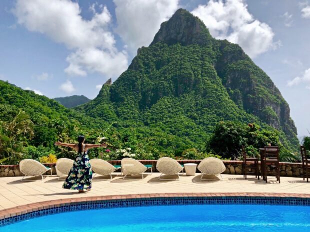 Woman enjoying mountain view in Saint Lucia surrounded by lush green nature and clear sky