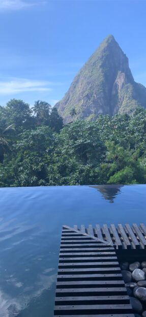 Stunning Saint Lucia mountain surrounded by lush greenery and calm water view