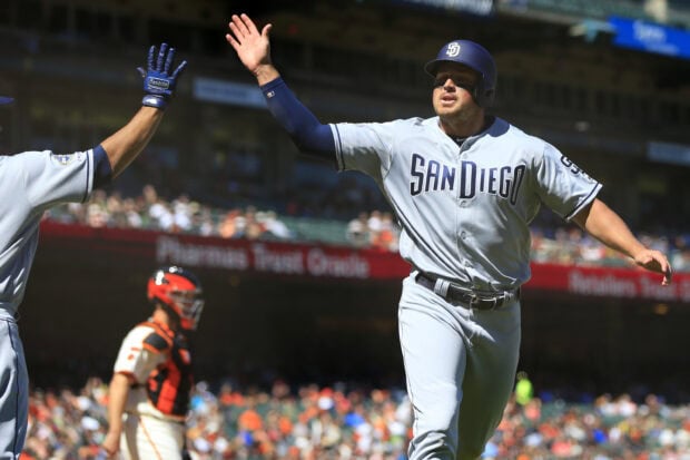 A San Diego Padres player high fives a teammate after scoring during a baseball game, 2K Desktop Wallpaper