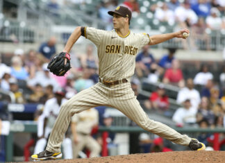 A San Diego Padres player throws a pitch during a baseball game in front of a crowded stadium, 2K Desktop Wallpaper