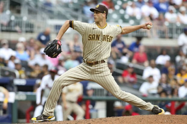 A San Diego Padres player throws a pitch during a baseball game in front of a crowded stadium, 2K Desktop Wallpaper