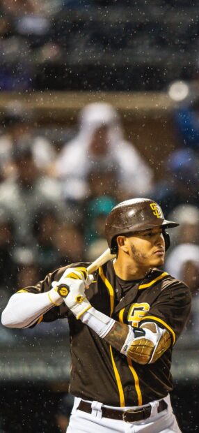 A San Diego Padres player is preparing to swing the bat during a rainy game, HD Phone Wallpaper