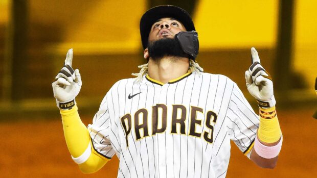 A San Diego Padres player looks upward with both hands raised after a play, HD Desktop Wallpaper