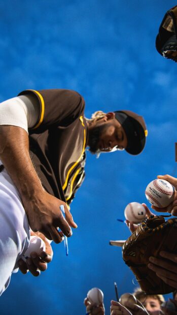 A San Diego Padres player signs autographs for fans during a game, HD Phone Wallpaper