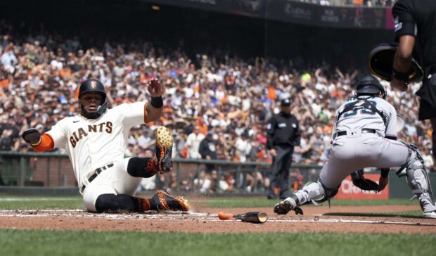 A San Francisco Giants player slides safely into home plate during a Major League Baseball game, 2K Desktop Wallpaper