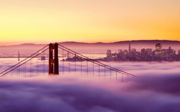 San Francisco skyline viewed above the fog with the Golden Gate Bridge towers standing tall