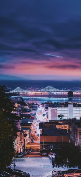Night view of San Francisco skyline with illuminated bridge and city streets in 2K quality