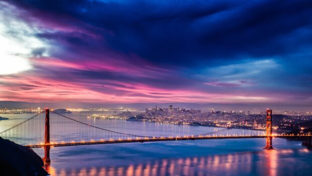 San Francisco skyline with the Golden Gate Bridge at sunset and colorful clouds