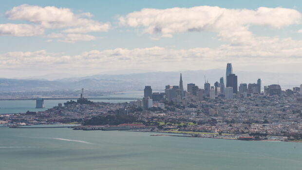 A clear view of San Francisco skyline with city buildings and bay waters on a sunny day