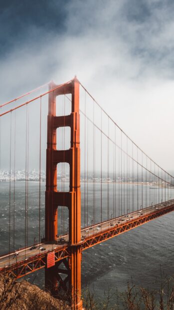 Close up view of San Francisco skyline with the Golden Gate Bridge under cloudy sky