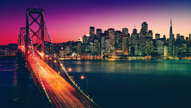 San Francisco city skyline viewed from the bay with illuminated buildings at sunset