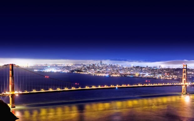 Night view of San Francisco skyline with the Golden Gate Bridge illuminated in HD quality