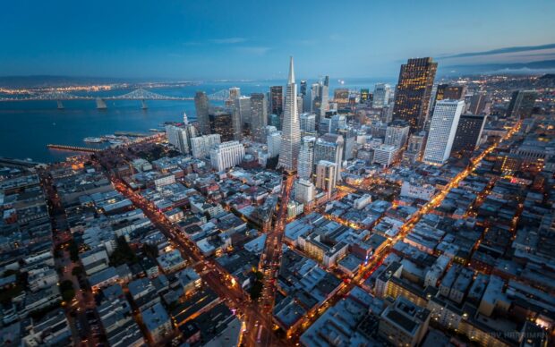 Nighttime view of San Francisco skyline with city lights and Transamerica Pyramid in HD