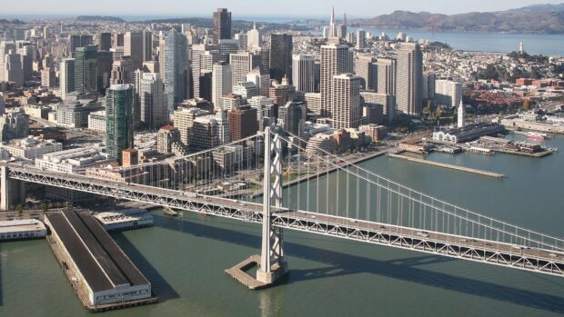 San Francisco skyline featuring the iconic Bay Bridge and towering city buildings