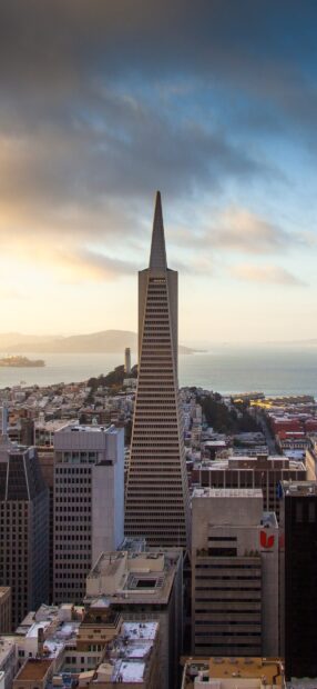San Francisco skyline with the iconic Transamerica Pyramid against a cloudy sky