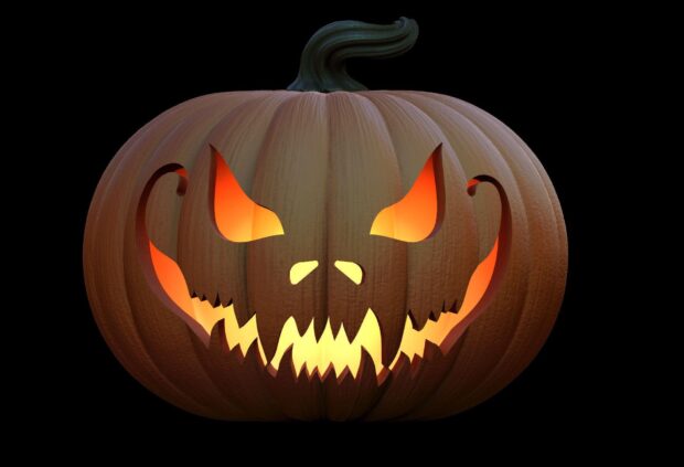 A glowing Halloween pumpkins with a sinister carved face on black background, HD Desktop Wallpaper