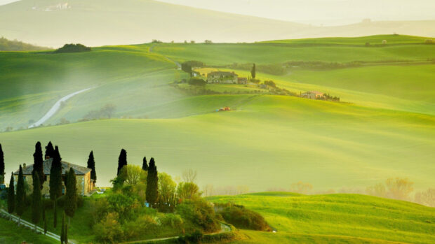 The green hills wallpapers show rolling fields and country houses under soft sunlight, 2K Desktop Wallpaper