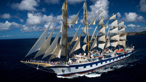 A majestic schooner sailing on the deep blue ocean under a bright sky