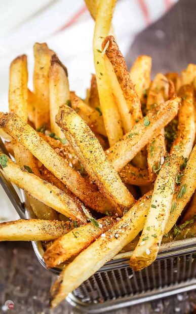 A close up view of seasoned French fries in a metal basket ready to eat, HD Mobile Wallpaper