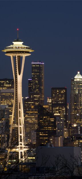 The Seattle skyline at night features the illuminated Space Needle and nearby buildings, 2K Phone Wallpaper