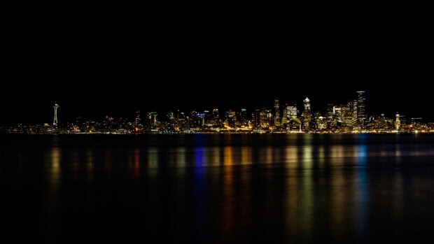 The Seattle skyline wallpapers show the city lights reflecting over calm water at night, 4K Desktop Wallpaper