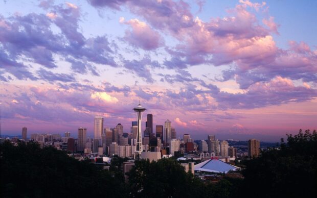 The Seattle skyline features iconic buildings under a colorful sky, HD Desktop Wallpaper