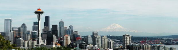 The Seattle skyline features iconic buildings and Mount Rainier in the background, 4K Desktop Wallpaper