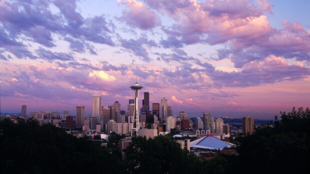 The Seattle skyline at sunset shows vibrant clouds above the cityscape, HD Desktop Wallpaper