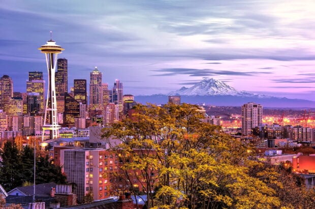 The vibrant Seattle skyline is shown during sunset with Mount Rainier in the background, 2K Desktop Wallpaper