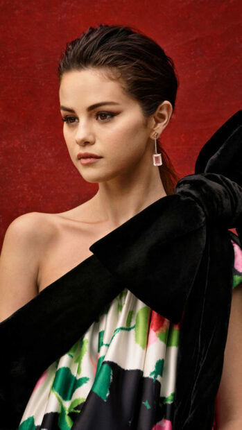 Selena Gomez wallpapers show her in a colorful dress with a red background, 2K Mobile Wallpaper