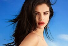 Selena Gomez wears star shaped earrings with a blue sky background, 2K Desktop Wallpaper