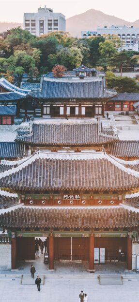 Traditional Seoul Korea architecture with ancient palace gates and tiled roofs in autumn