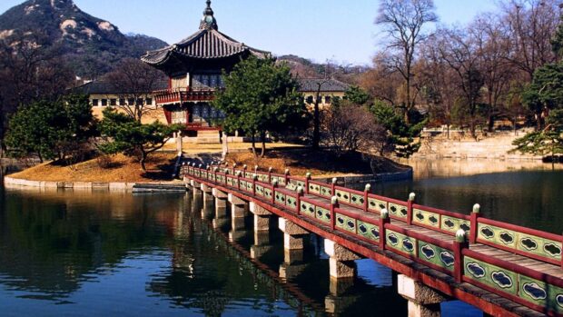 Traditional Seoul Korea with wooden bridge over lake and pavilion in autumn scenery