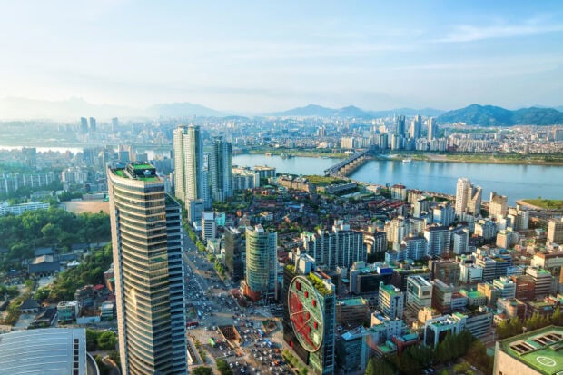 A panoramic view of Seoul Korea cityscape with tall buildings and river in the background