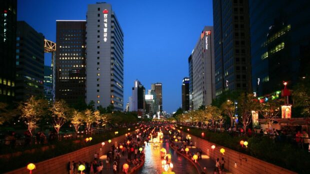 Night view of Seoul Korea city river with lanterns and buildings at dusk