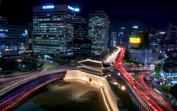 Night view of Seoul Korea with historic gate and busy city traffic lights
