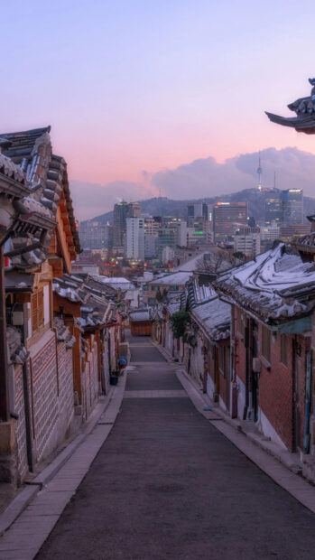 Traditional Seoul Korea street with snow covered roofs at sunset