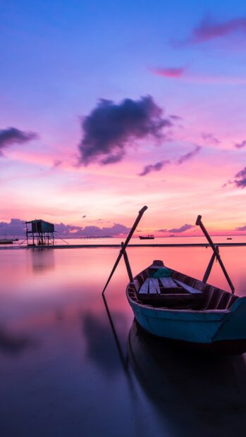 A calm boat floats on still water during a colorful sunset scenery Wallpapers, 4K Mobile Wallpaper