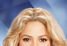 Shakira smiles warmly with long golden hair and a shiny outfit, 4K Phone Wallpaper