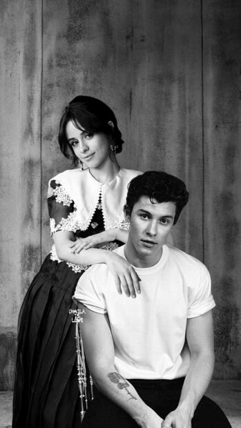 Shawn Mendes with a woman posing together in a black and white portrait