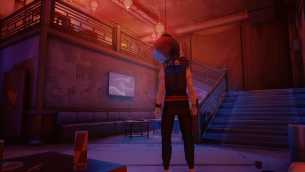 A Sifu character standing in a dimly lit room with stairs and lanterns on walls